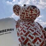 Inflatable advertising structure being set up with air blower system